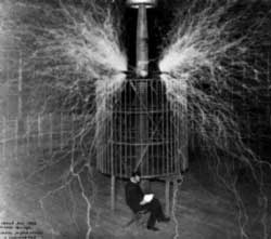Работа электрического осциллятора при напряжении в 12 миллионов вольт. Электрическое напряжение меняется 100000 раз в секунду и вызывает соединение азота с кислородом. Искры имеют длину около 65 футов (21 метр). Тесла сидит перед осциллятором. Колорадо Спрингс, 1899–1900